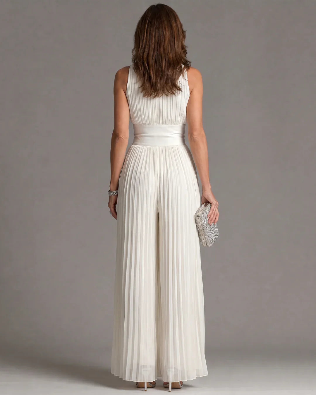 Tuta in chiffon bianca senza maniche con scollo a V, zip e pantaloni a gamba larga plissettati
